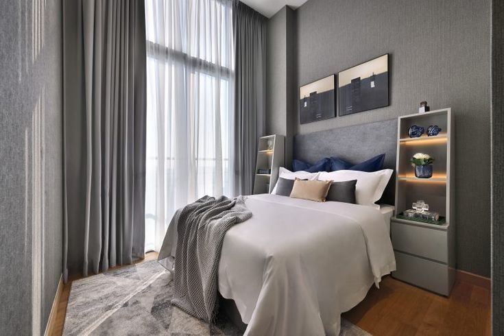 Modern luxury interior design - a bedroom with a neutral color scheme of grey and white to embrace sophistication.
