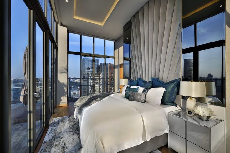 Modern luxury interior design - a bedroom with a panoramic view of the outside and perfect connection of outdoors with indoors. 