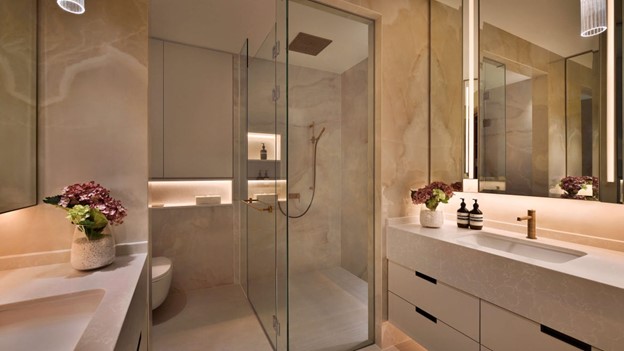 Modern luxe interior design - a bathroom scene with a glass shower door and other functional elements.